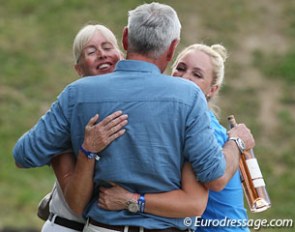 Rob Hanna hugs his wife Mary and Kristy Oatley