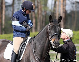 Burkhard Ernst giving his wife Monica a hand when she takes off her jacket to ride the Ukrainian warmblood Tonic