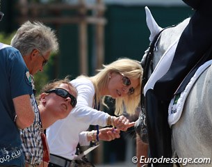 Eilberg's posse, including Louise Bell, inspects the nose bleed with which Delphi left the arena. The mare was inspected by the FEI vet who diagnosed the bleeding as minor.