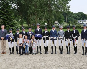 Judge, Torleif Siegel congratulates winners Eva Möller and Lars Ligus as well as the other placed riders in the Bundeschampionat Qualification for five-year-old dressage horses.