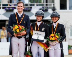Frederic Wandres, Isabell Werth, Charlott Maria Schurmann on the podium after the GPS at the 2026 German Championships :: Photo © Stefan Lafrentz