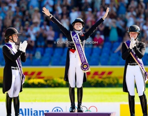 Charlotte Fry wins Grand Prix Special gold at the 2026 World Championships. Joined on the podium by Dufour and Hemmer :: Photo © Astrid Appels