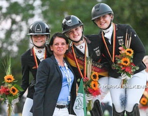 The pony podium at the 2026 German Youth Riders Championships with Kasselmann, Gosmann, and von Helldorff. Team trainer Caro Roost in front :: Photo © Mirka Nilkens