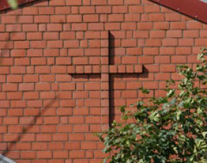 A cross in bricks. God protect this barn