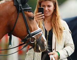 Swedish trainer Elin Aspnas takes a photo of her student Jennifer Lindvall's Hynder Hoeve's Ramses