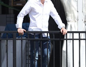 Former vet gone real estate agent Travis Laas watching his fiancee Caroline Roffman ride 