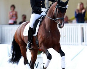 Dorothee Schneider waves to the crowds in her lap of honour on Stanford at the 2014 World Young Horse Championships :: Photo © Astrid Appels