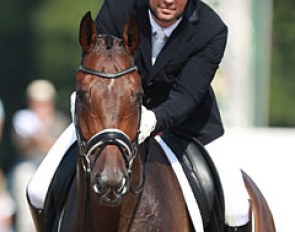 Riding for Belgium, Dutch Rob van Puijenbroek gives his Oldenburg gelding Seymour (by San Amour x Friedensfurst) a big pat. 