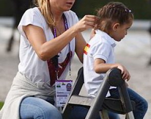 Braiding the hair of a very young Spanish fan