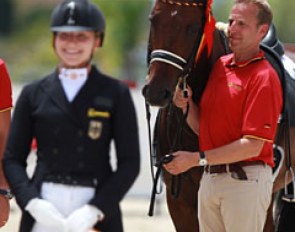 Dad Johannes Westendarp holds Der Prinz while daughter Alexa gets ready to mount the podium to receive the team gold medal