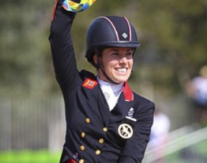 Charlotte Dujardin waving her gold medal