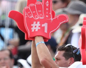 Charlotte Dujardin's biggest fan, fiancé Dean Wyatt Golding, waves his custom made foam fingers