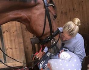 Jessica von Bredow-Werndl showing baby Moritz to her Grand Prix horse Zaire E