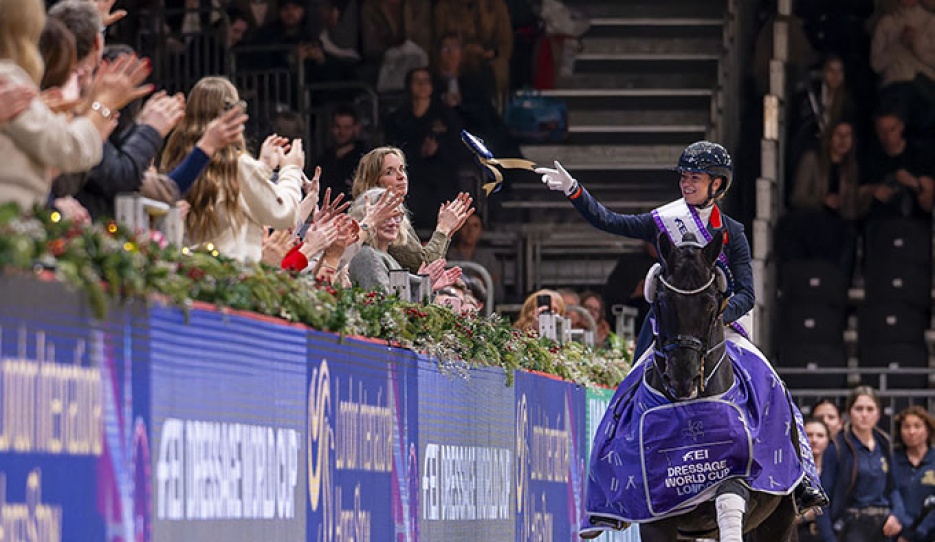 Fry throws her ribbon into the crowds during her lap of honour on Glamourdale at the 2025 CDI-W London :: Photo © Jon Stroud