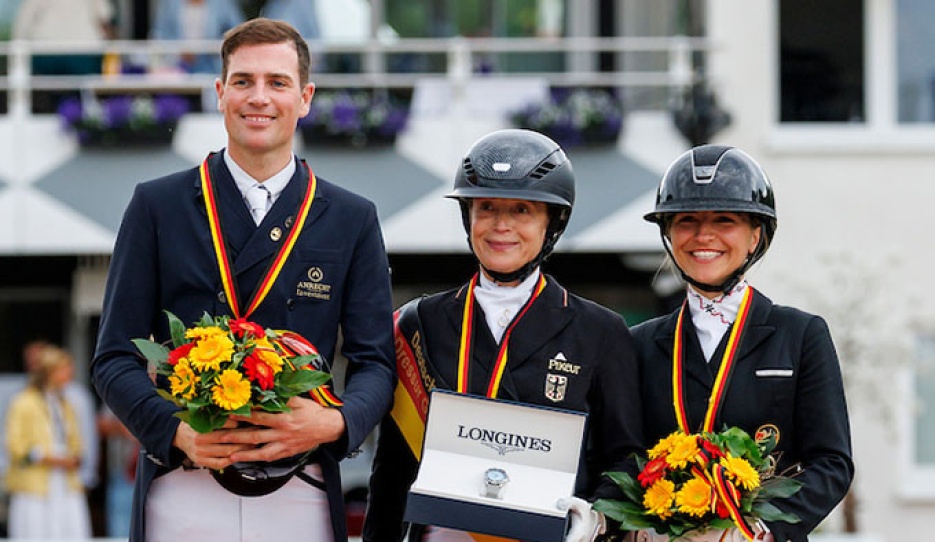 Frederic Wandres, Isabell Werth, Charlott Maria Schurmann on the podium after the GPS at the 2026 German Championships :: Photo © Stefan Lafrentz
