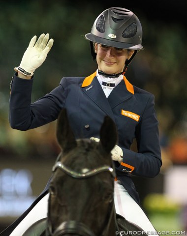 A smiling Katja Gevers wearing a helmet one sees more often in the show jumping (or polo) arena than the dressage ring