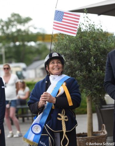 Shelly Francis raising the American flag as winner of the Grand Prix and Grand Prix Special