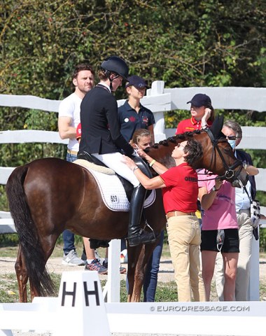 German pony team trainer Connie Endres gives Benner a supporting pat on the leg