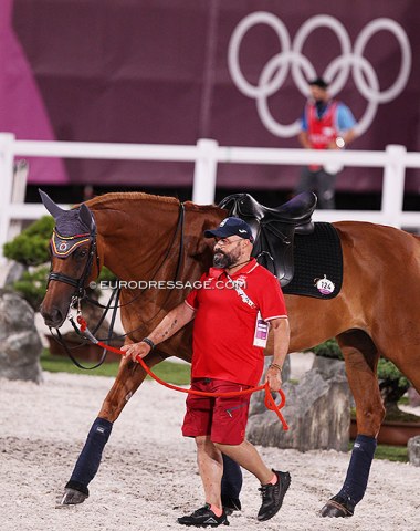 Spanish team farrier David Cannes hand walking Jose Mena's Divina Royal (reserve horse)