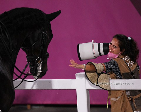 Spanish equestrian photographer Lily Forado reaching out to pat Naima Moreira Laliberte's Statesman