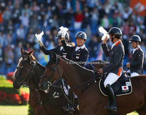 Japanese dressage riders Kazuki Sado and Shingo Hayashi join the Japanese show jumpers in the closing ceremony and parade of nations
