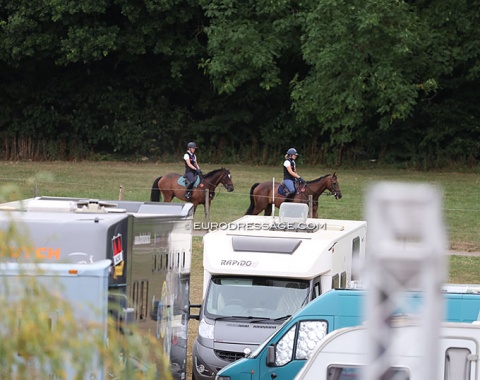 Eventers hacking their horses as the dressage team test get underway
