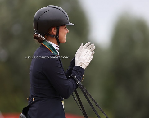 Portugal's Francisca Monteiro clapping for her young rider team mate Marta Fernandes Marquis who finished round the same time as she left the arena