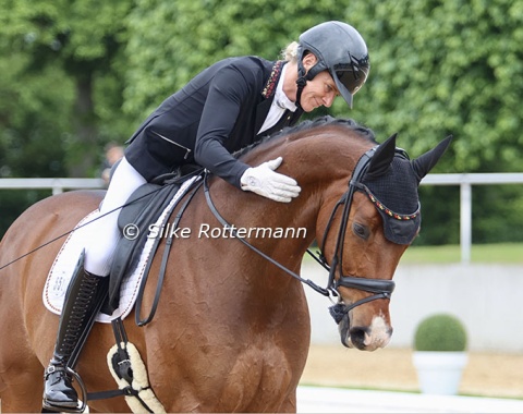 Melanie Wienand gives her 11-year-old Hanoverian a big pat at the end of their ride in the Grand Prix A test.
