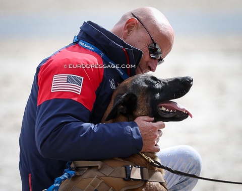 Steffen Peters cuddling with Caroline Hordum's dog