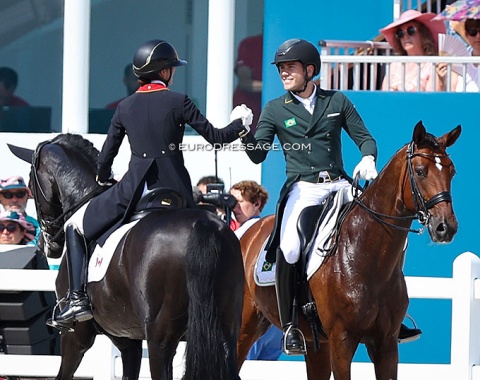 Naima Moreira Laliberte and Joao Oliva high five as one leaves and the other enters the arena