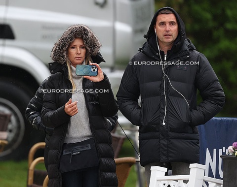 Sarah Pidgley and Andreas Helgstrand in the rain watching Annabella Pidgley warm up Vamos Amigos