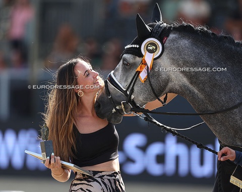 Breeder Yolien van Maasacker cuddles with Proud James