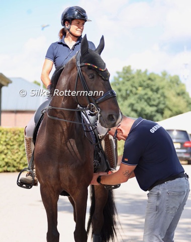 Germany’s Isabell Nowak and Siracusa OLD getting ready for training with the help of her husband