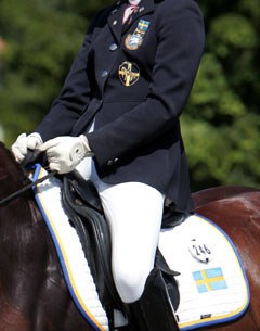 A Swedish riding outfit: Swedish patches on jacket and flag on saddle pad :: Photo © Astrid Appels