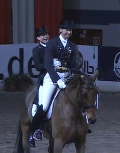 Isabell Werth and Patrik Kittel share the ride on First Class for the 2009 CDI Bremen lap of honour