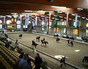 Riders practicing in the indoor school. Many of them were not wearing helmets. Shame on them!