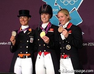 Adelinde Cornelissen, Charlotte Dujardin, and Laura Bechtolsheimer showing off their medals at the press conference