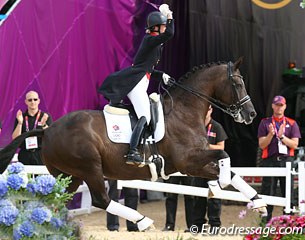 Valegro in a powerful canter stride while Charlotte waves her gold medal to the crowds