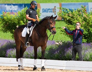 Steffen Peters on Rosamunde getting instructions from U.S. team trainer Robert Dover at the 2014 CDI Frizens in Austria