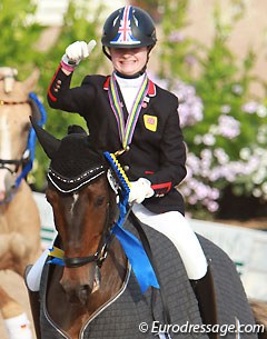 Phoebe Peters pointing the "Anky finger" at her pony SL Lucci in their lap of honour