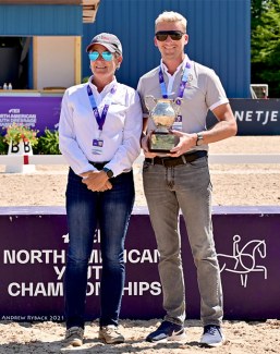 Roberta Williams hands Benjamin Pfabe the Patsy Albers Award Perpetual Trophy at the 2021 NAYRC :: Photo © USDF