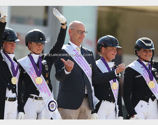 German chef d'equipe Klaus Roeser points at Germany's golden girls at the 2021 European Dressage Championships :: Photo © Astrid Appels
