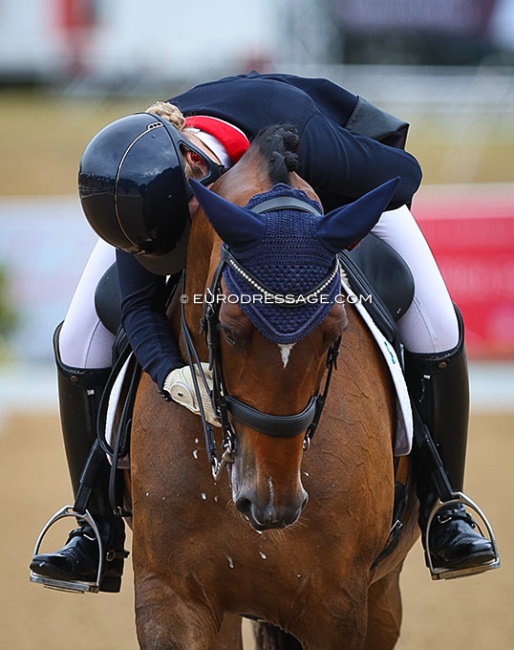 Anna Dalrymple hugging Vagabond de Massa at the end of her test at the 2022 European Young Riders Championships :: Photo © Astrid Appels