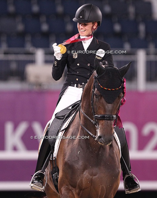 Jessica von Bredow-Werndl looking at her Tokyo Olympic gold medal :: Photo © Astrid Appels