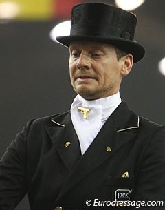 Edward Gal with a golden Glock Gun as pin for his stock tie :: Photo (c) Astrid Appels