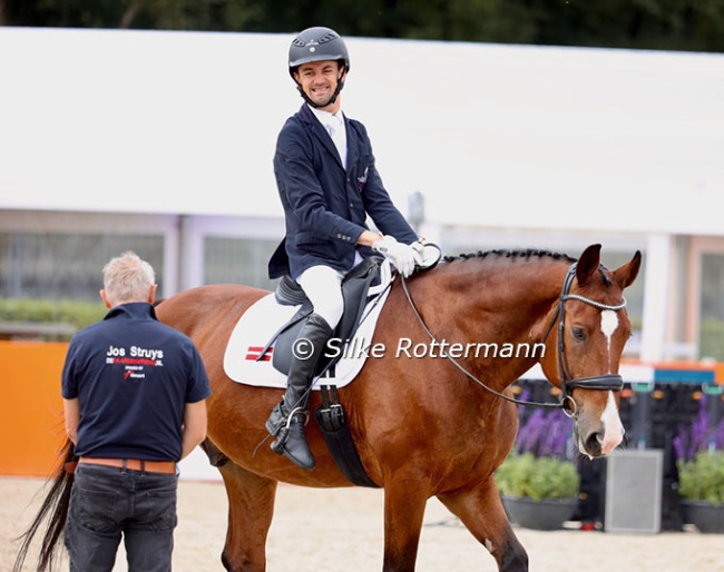 Rihards Snikus on King of the Dance, smiling at gate keeper Jos Struys, at the 2025 European Para Dressage Championships :: Photos © Silke Rottermann